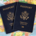 Pair of passports laying on a map of the world.