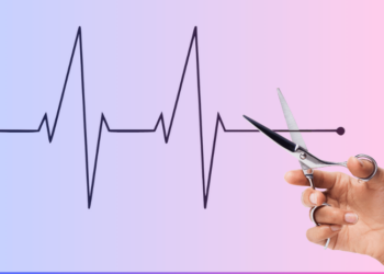 Scissors cutting line on heart monitor symbolizing cuts in Medicaid.