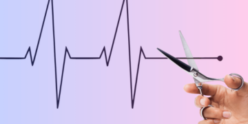 Scissors cutting line on heart monitor symbolizing cuts in Medicaid.